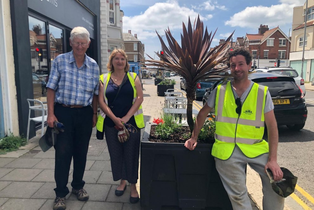 TV gardener helps volunteers revive planters in shopping street. Published by Brighton and Hove Independent.